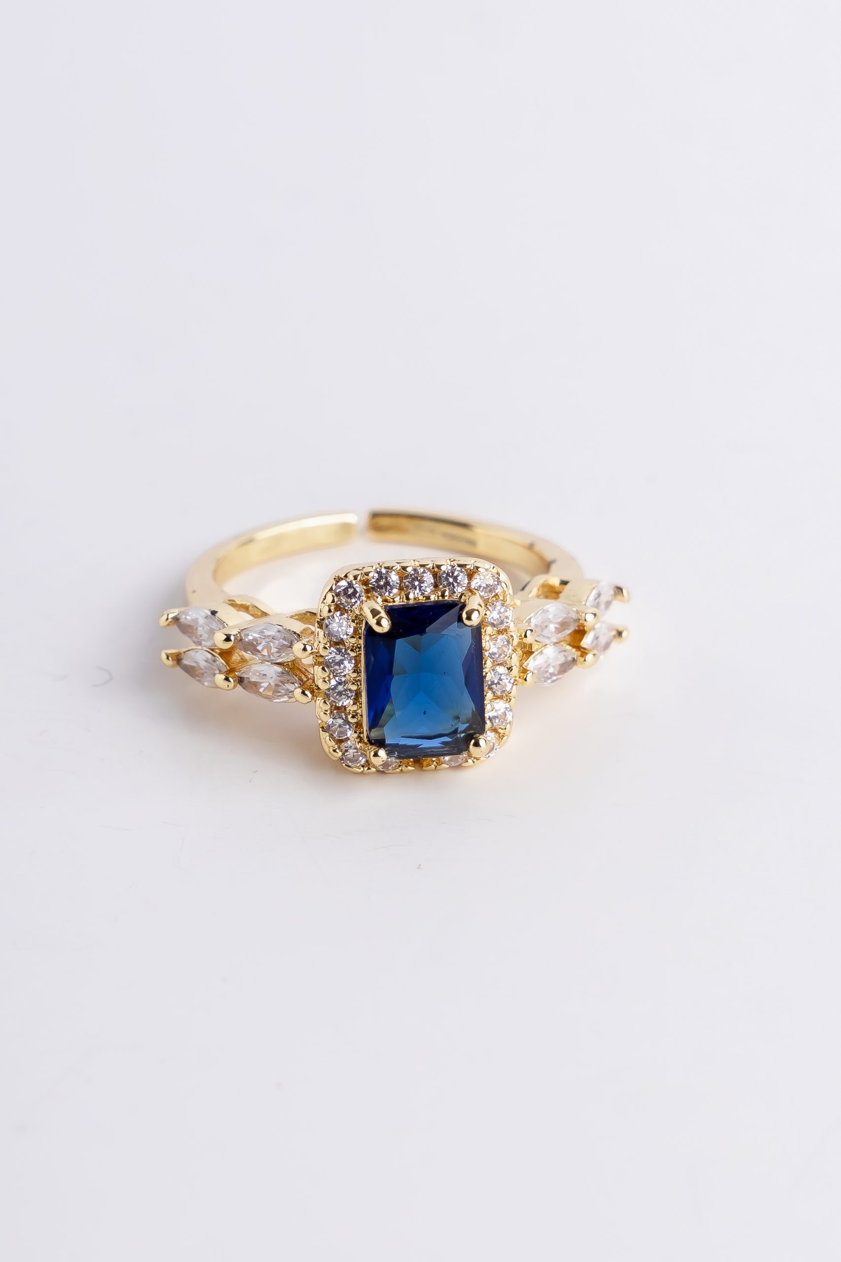 gold blue emerald cut halo ring